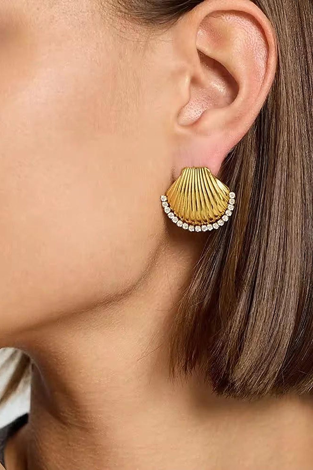Gold scallop shell earring worn